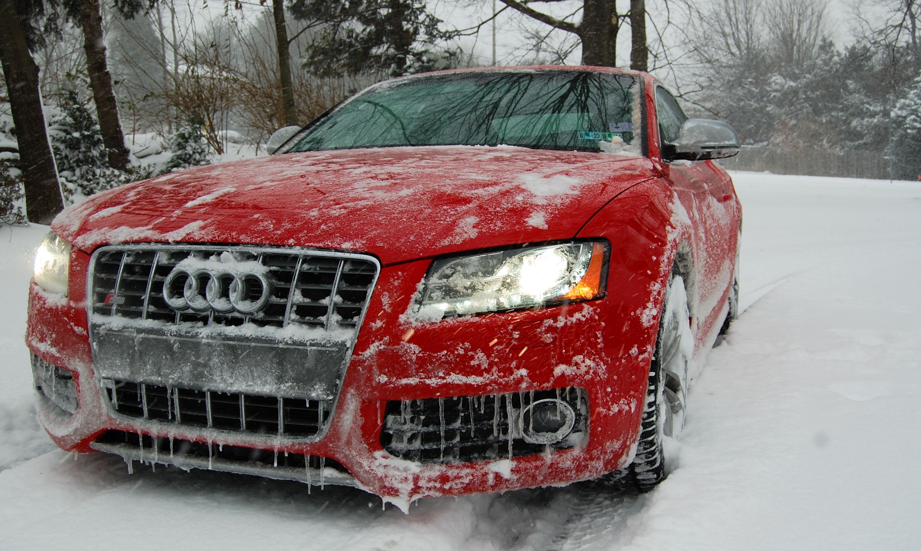 Red Audi in snowy landscape