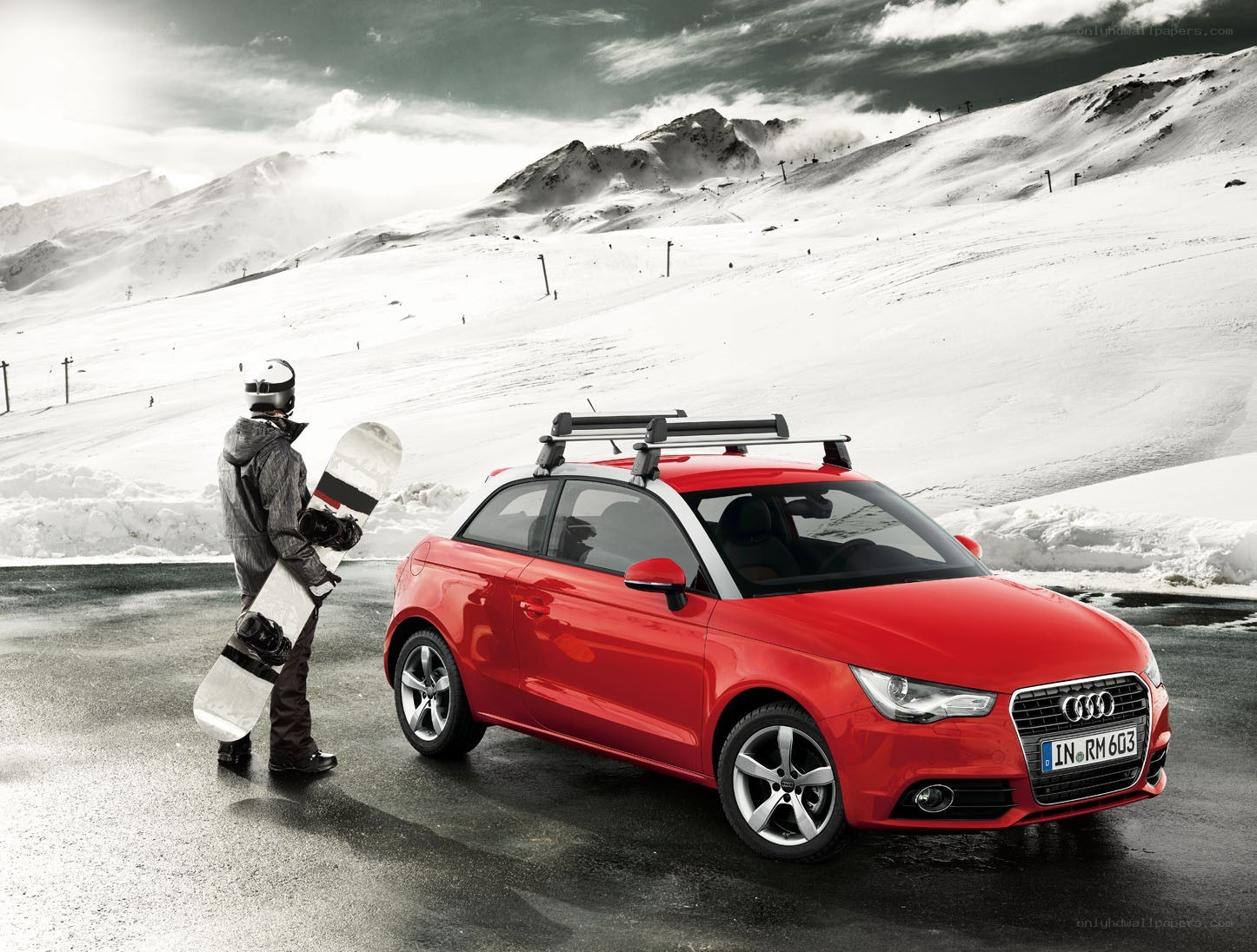 Red Audi in snowy mountains