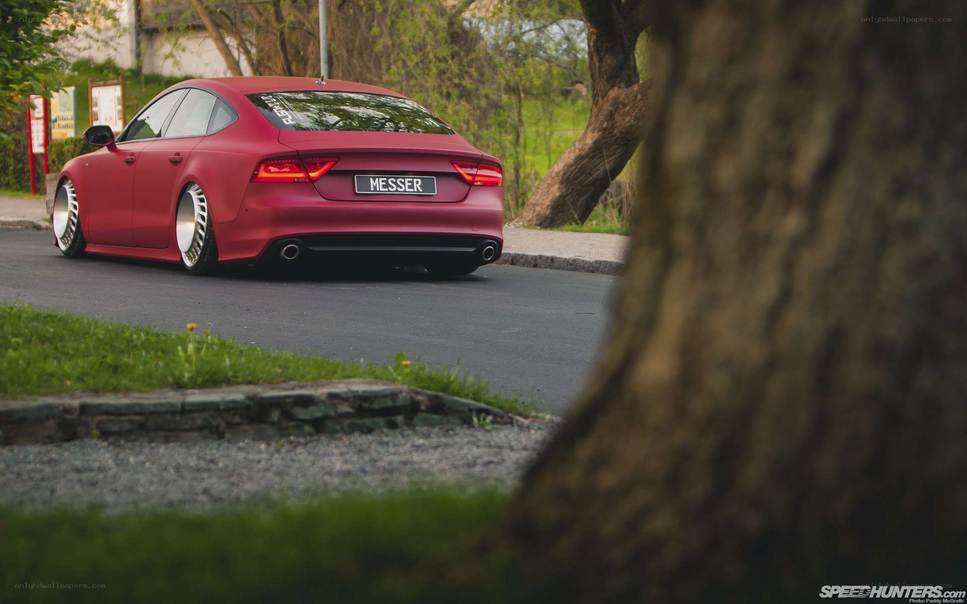 Red Audi on a quiet road