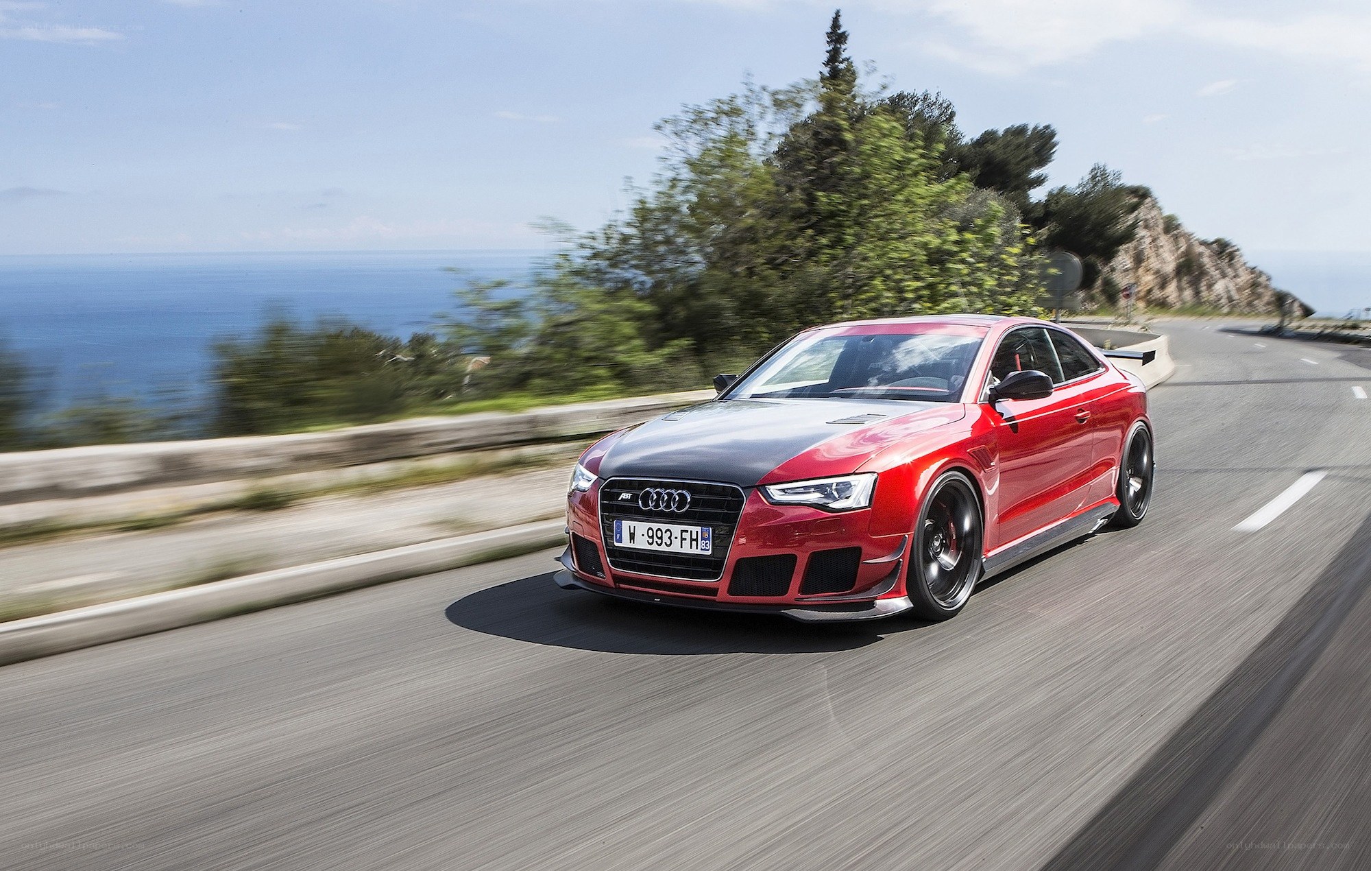 red audi on coastal road