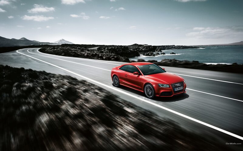 Red Audi on coastal road