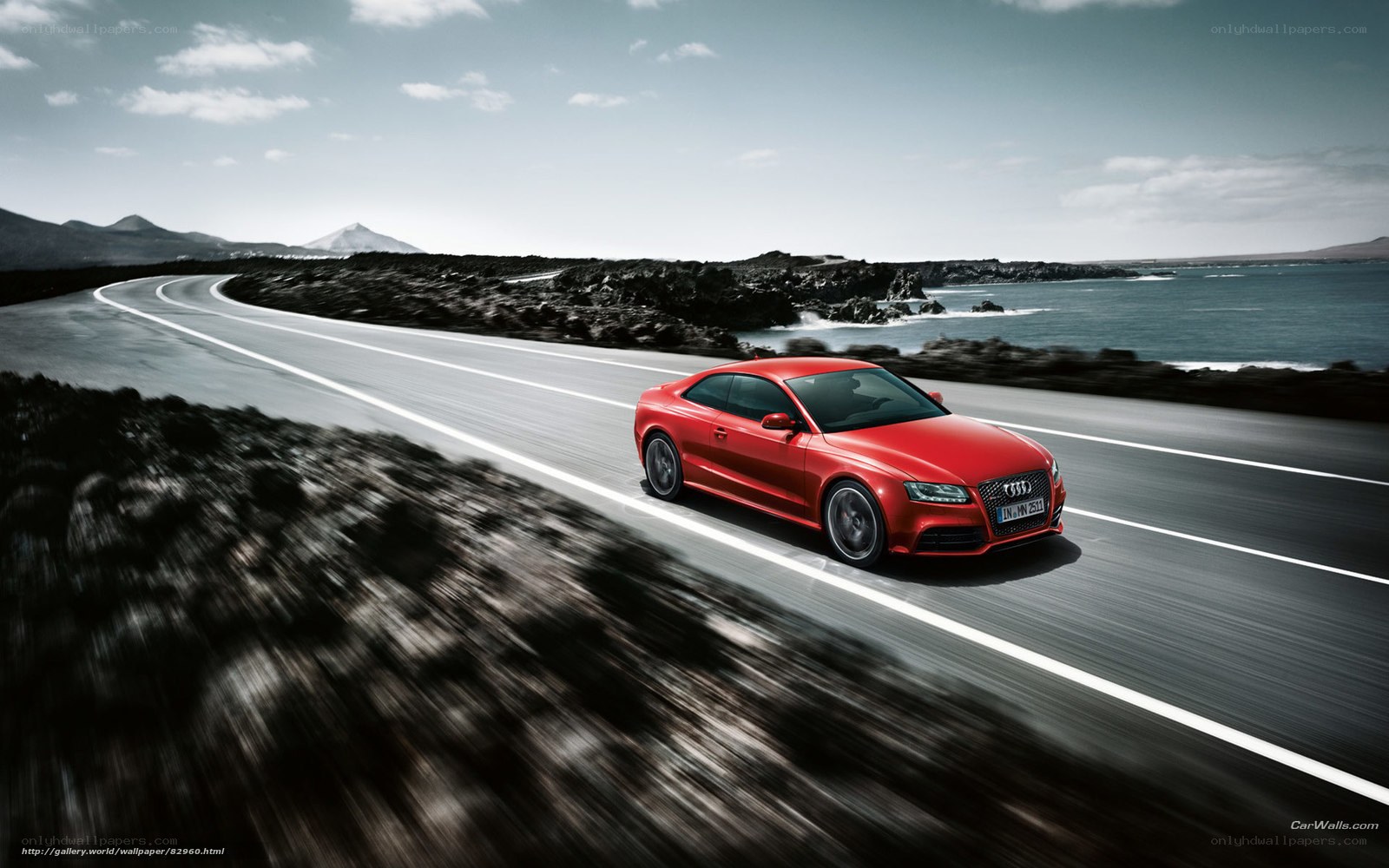 Red Audi on coastal road