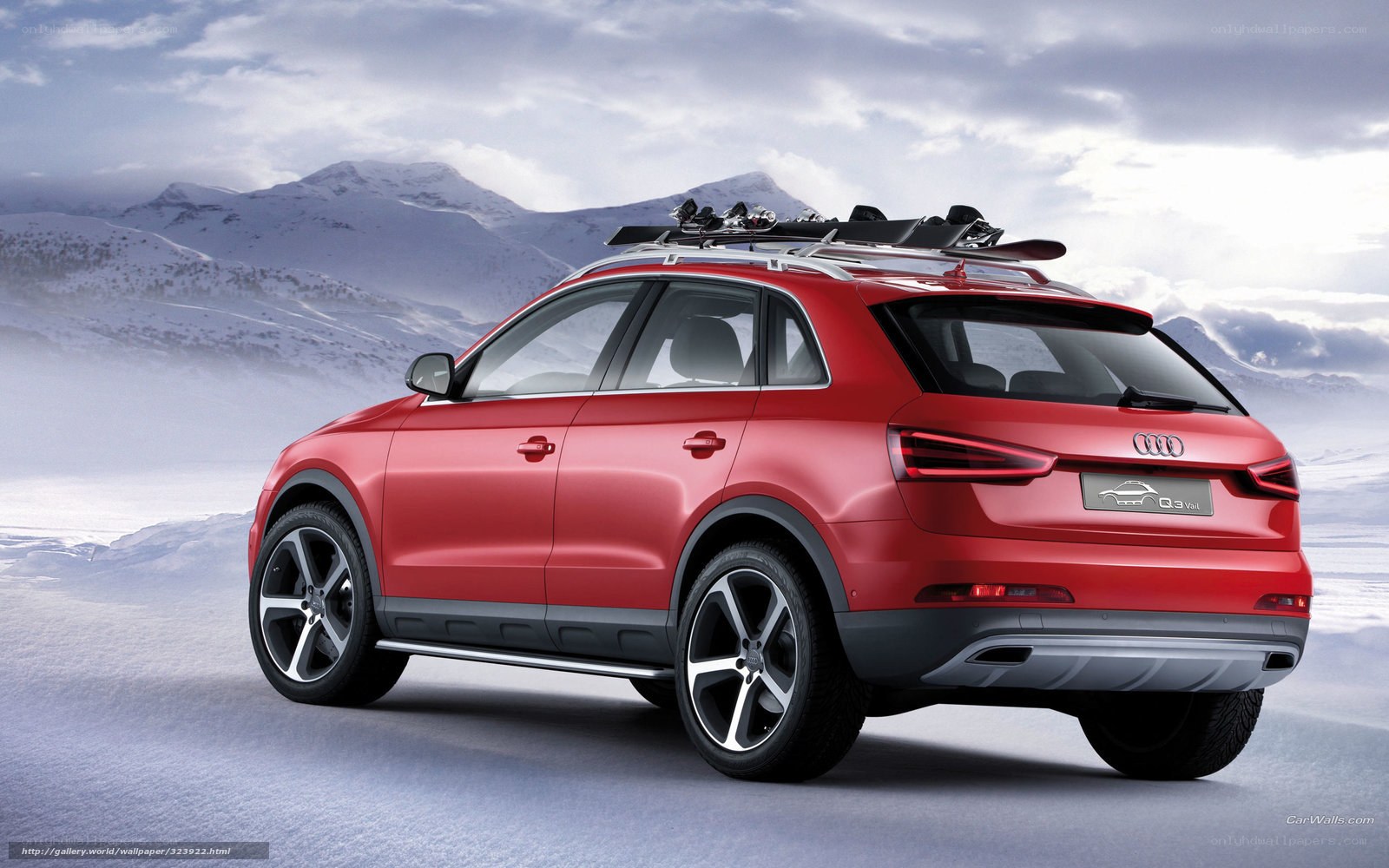 Red Audi Q3 in snowy mountains