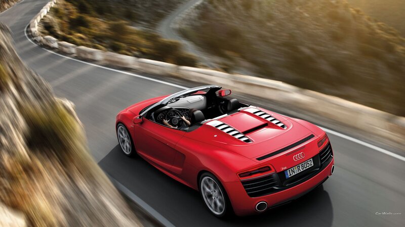 Red Audi R8 driving on a winding road
