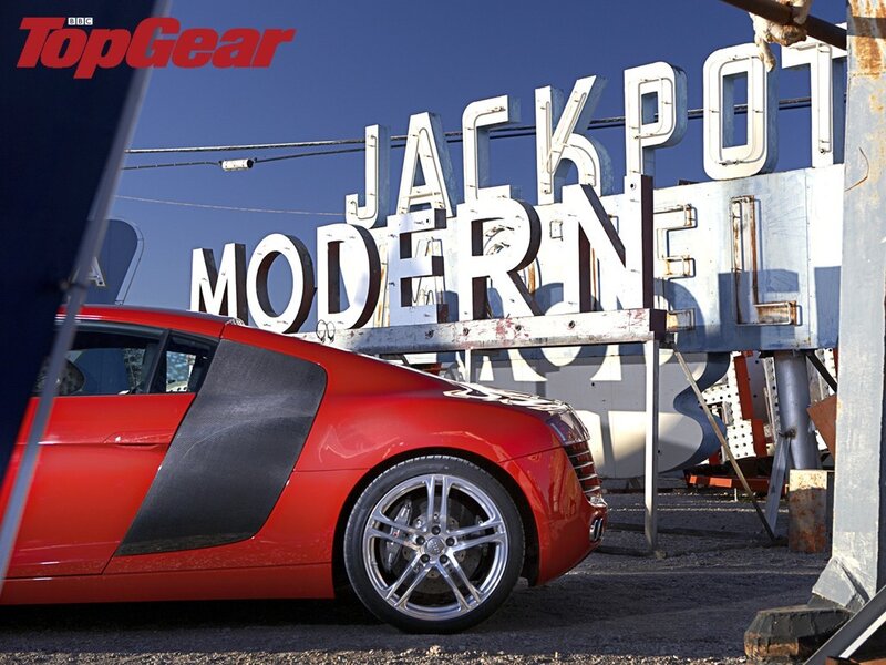 Red Audi R8 in front of sign