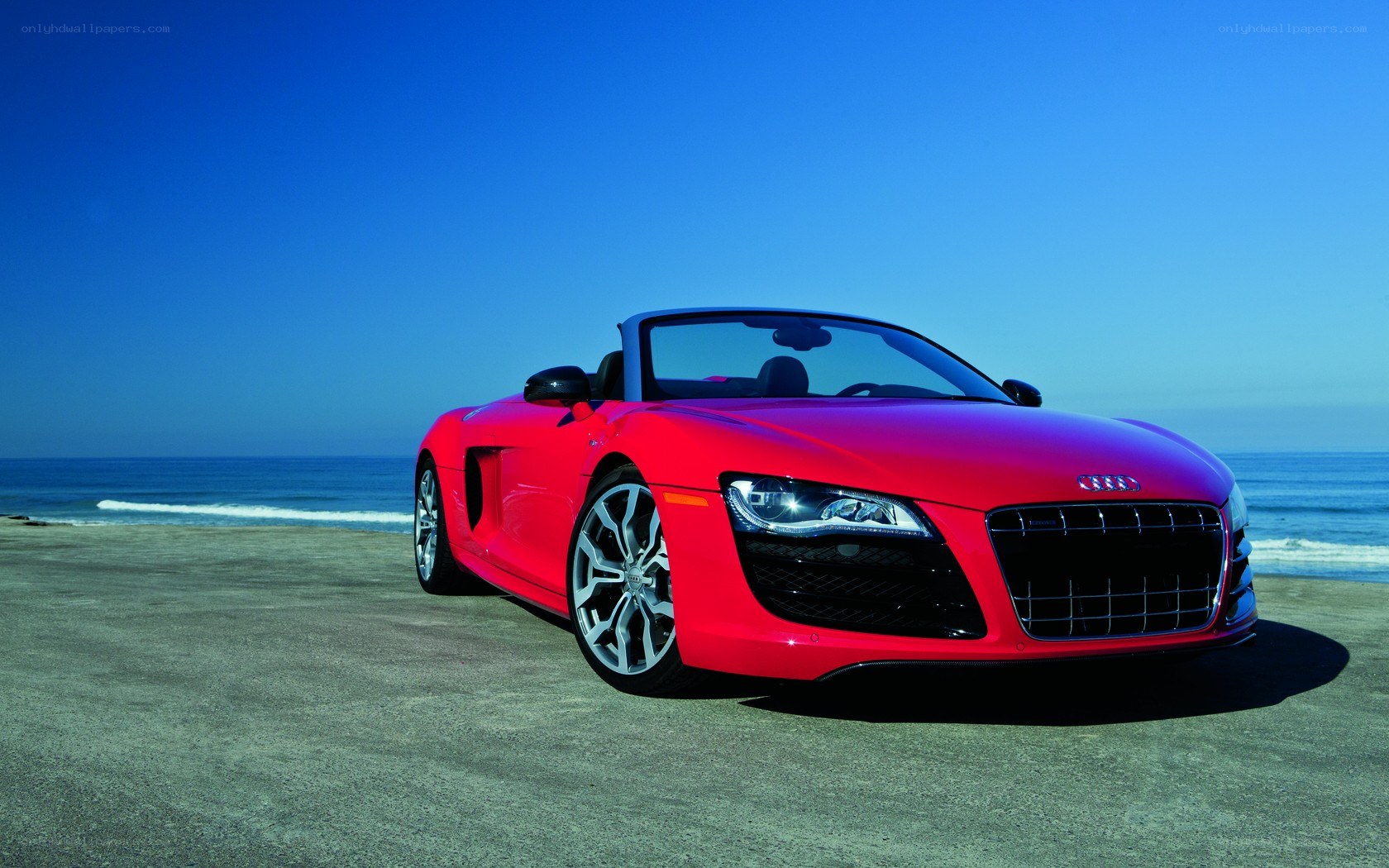 Red Audi R8 on beach