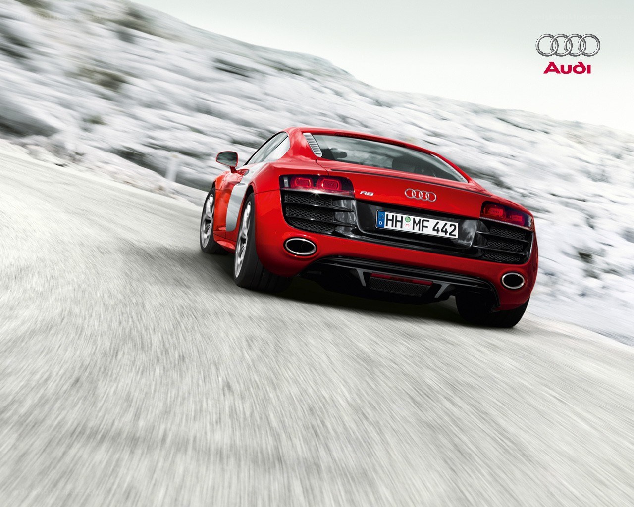 Red Audi R8 on snowy road