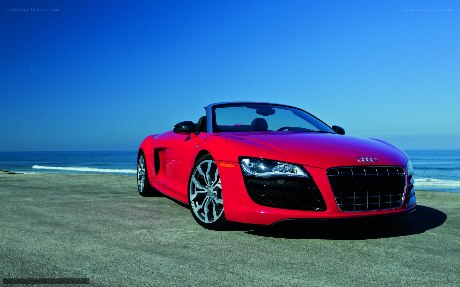Red Audi R8 Spyder on beach