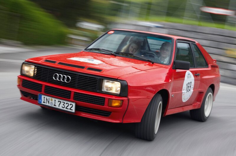 Red Audi rally car in motion