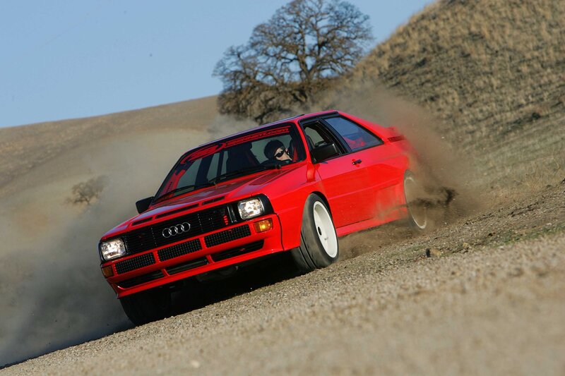 Red Audi rally car on dirt road
