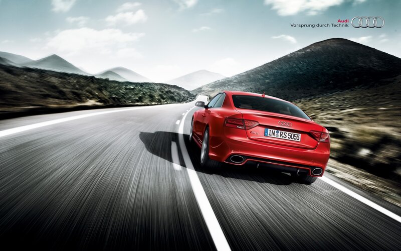 Red Audi RS driving on mountain road