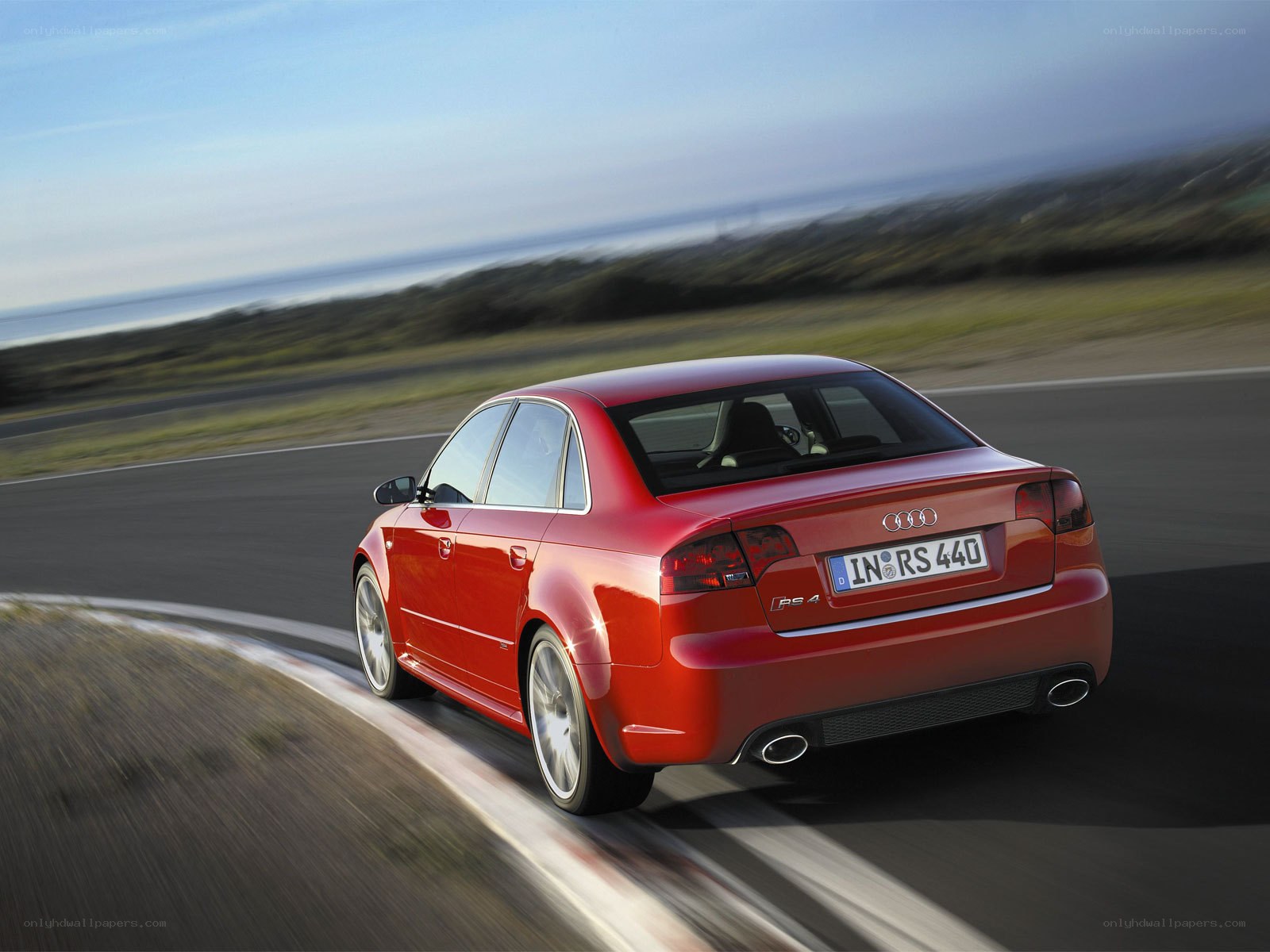 Red Audi RS4 on a winding road