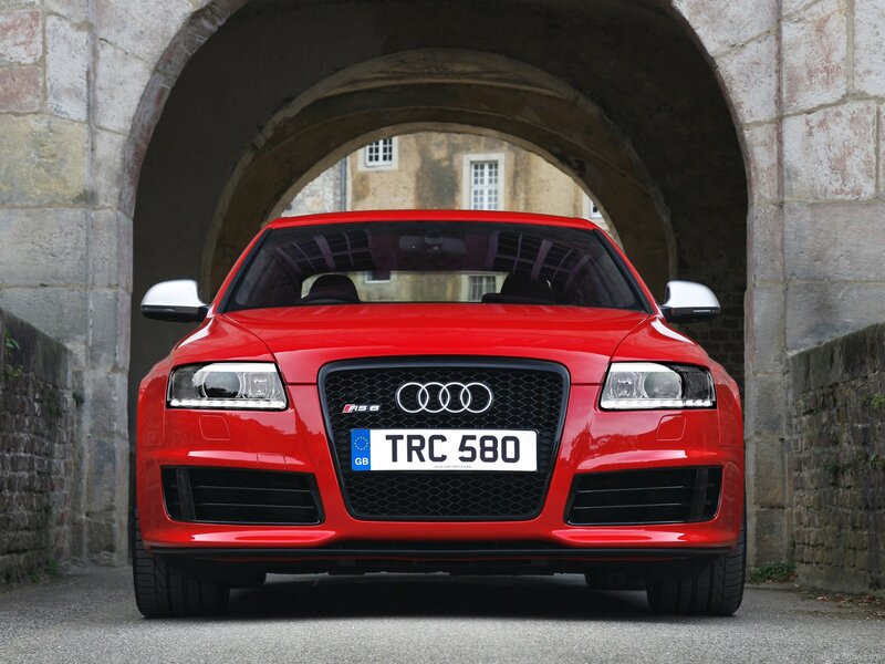 Red Audi RS6 under stone arch