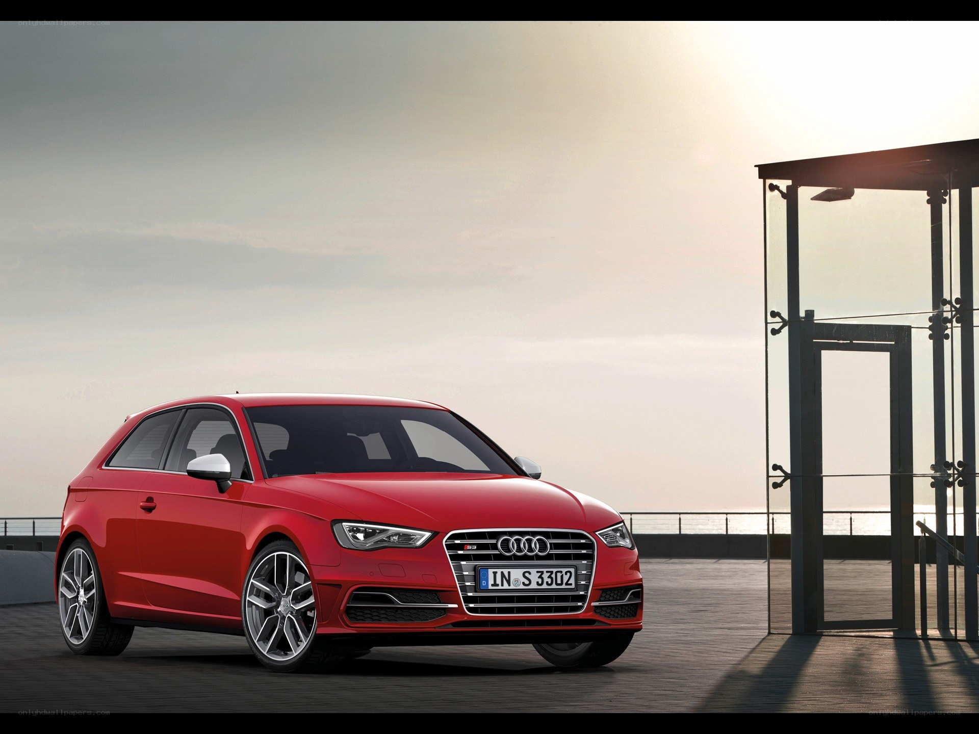 Red Audi S3 parked by the sea