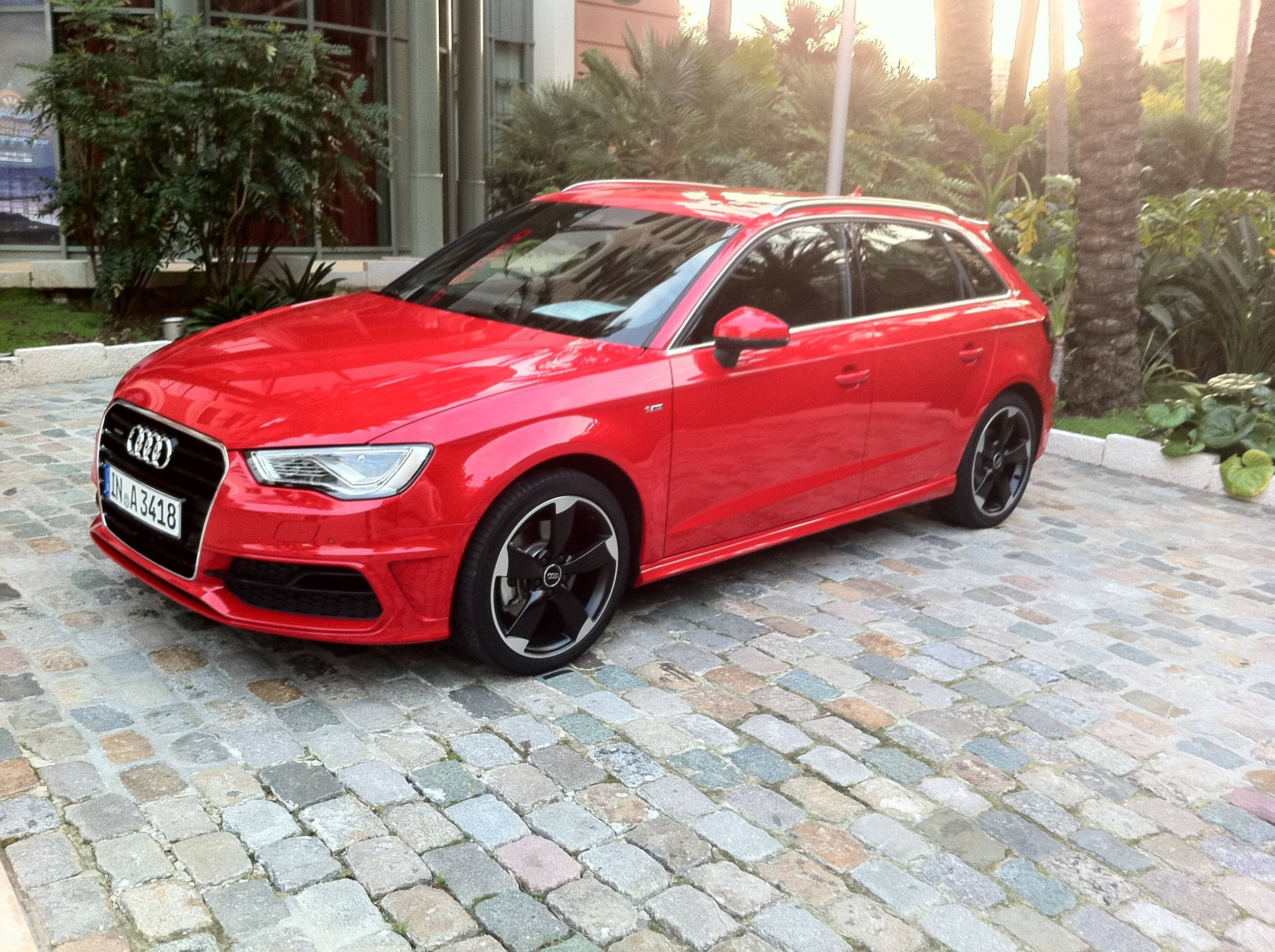 Red Audi S3 parked on cobblestones