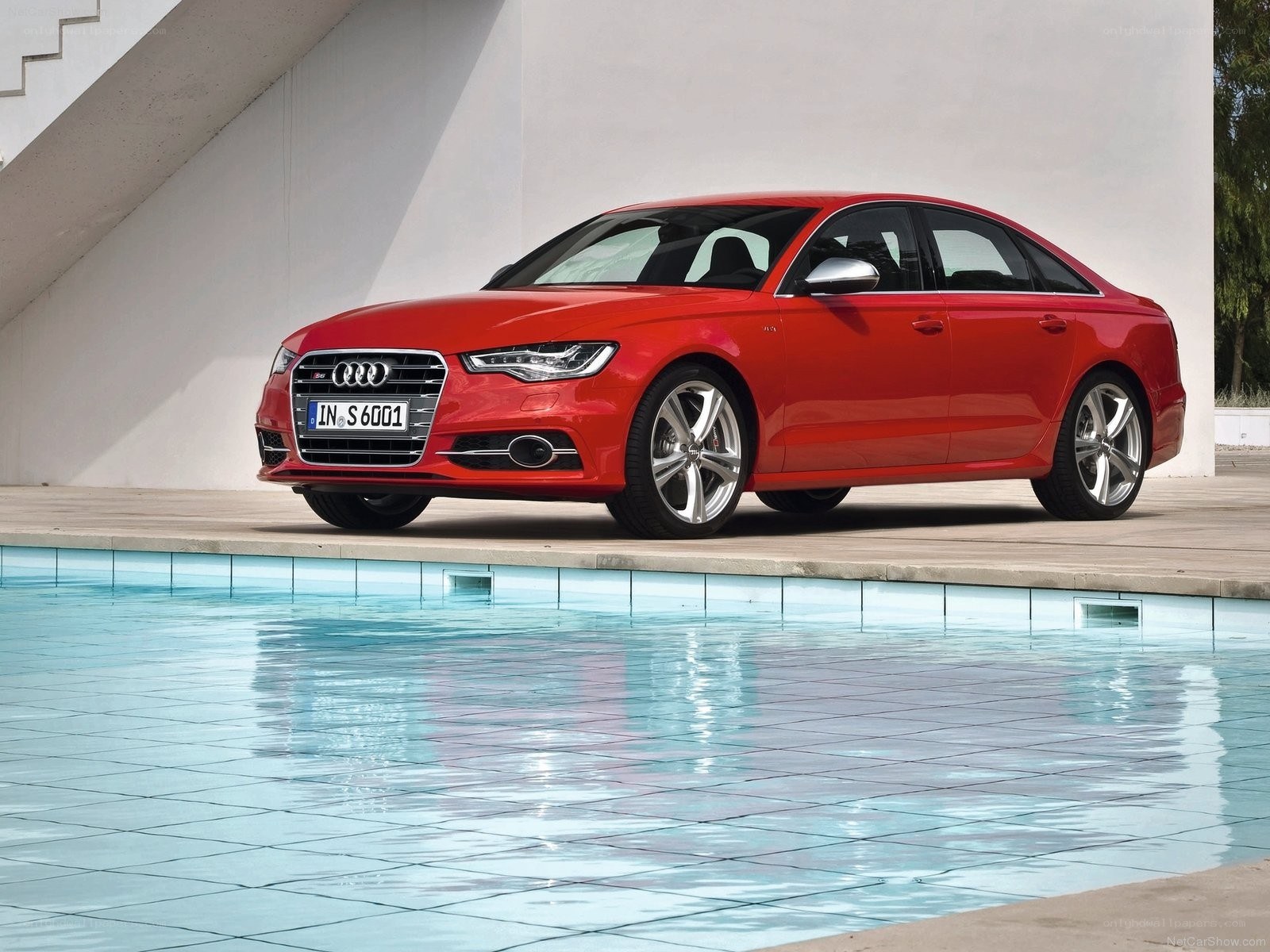 Red Audi S6 by pool