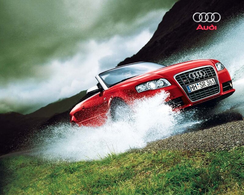 Red Audi splashing through water