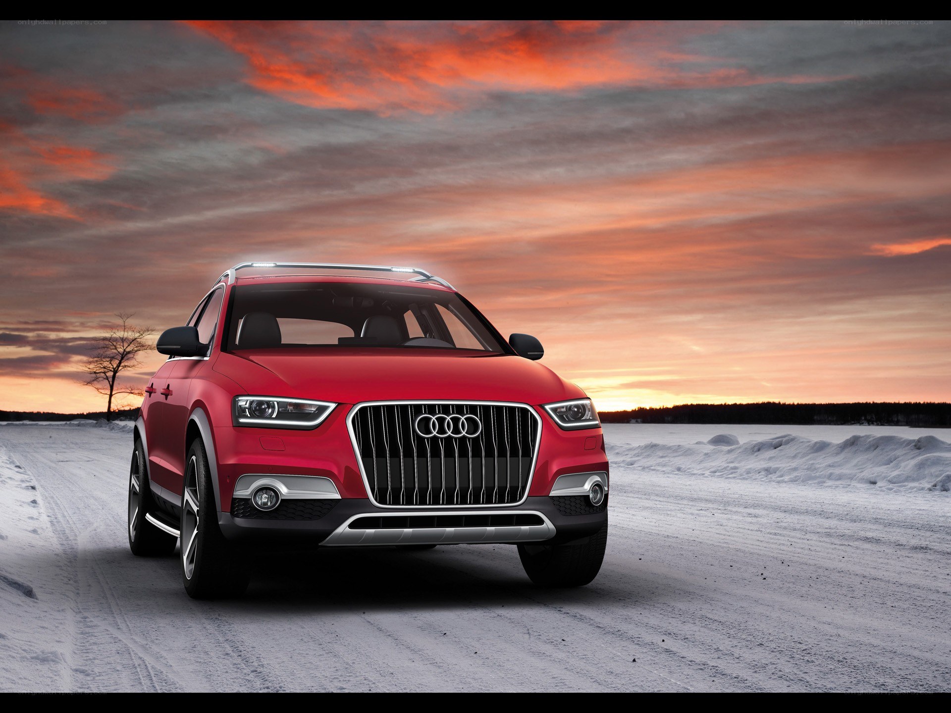 Red Audi SUV in snowy landscape