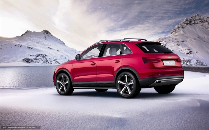 Red Audi SUV in snowy landscape