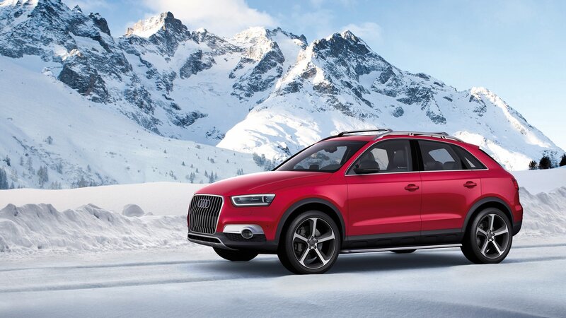 Red Audi SUV in snowy mountains