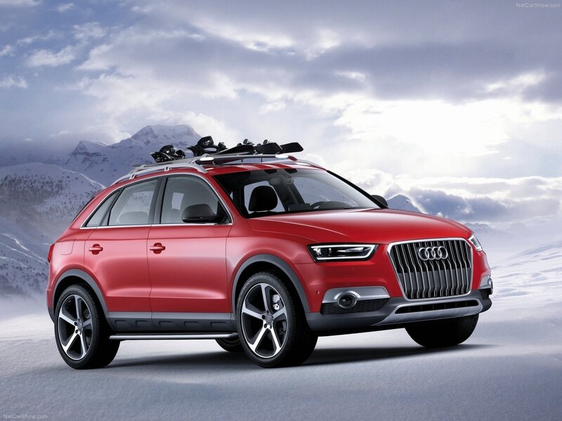 Red Audi SUV in snowy mountains