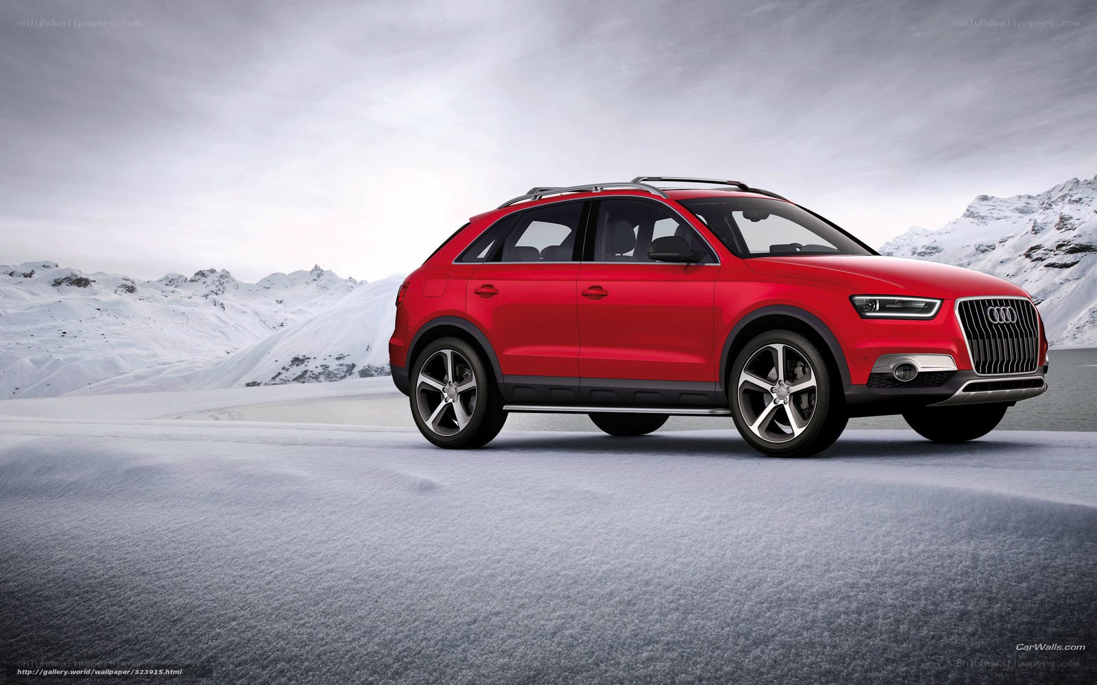 Red Audi SUV in snowy mountains