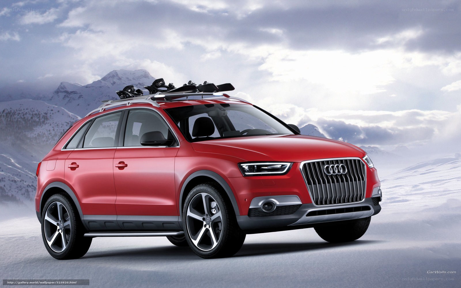 Red Audi SUV in snowy mountains