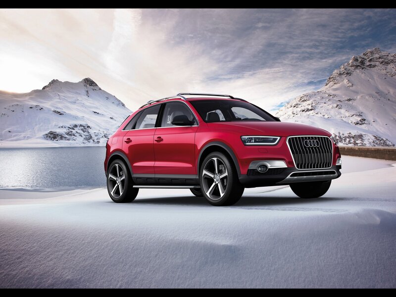 Red Audi SUV in snowy mountains