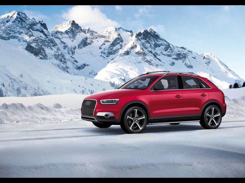 Red Audi SUV in snowy mountains