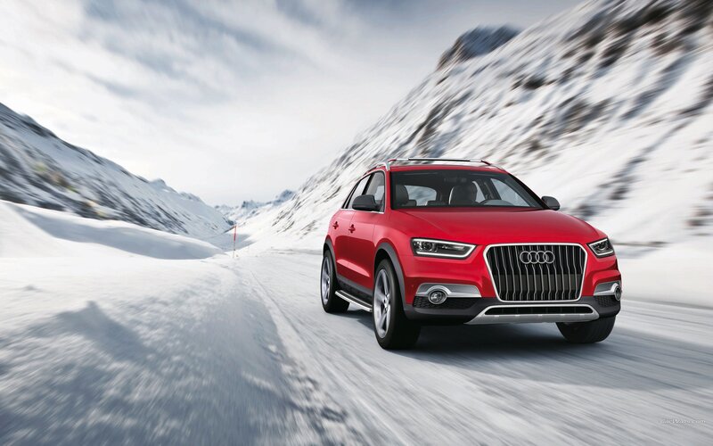 Red Audi SUV on snowy mountain road