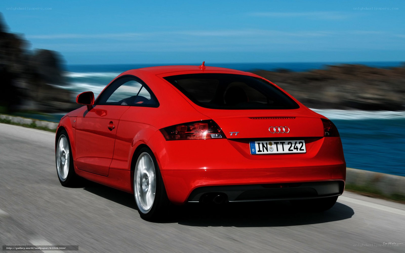 Red Audi TT driving on coastal road