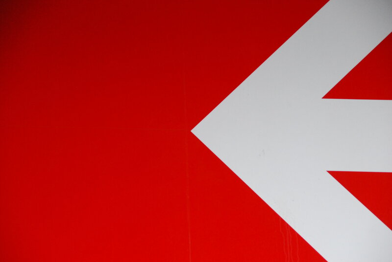 Red background with white arrow
