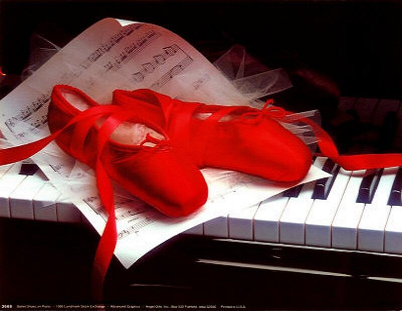 Red ballet shoes on piano