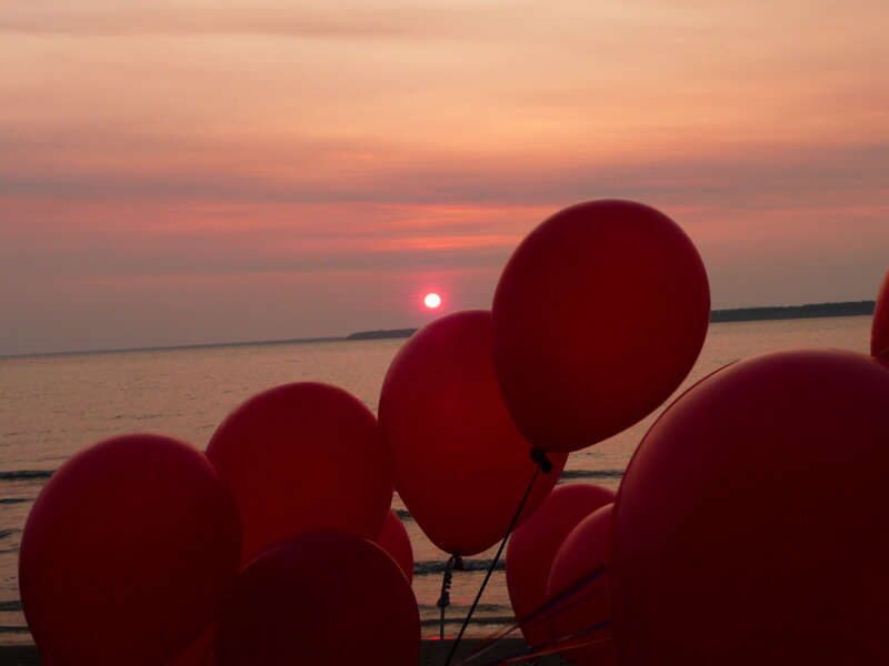Red balloons at sunset