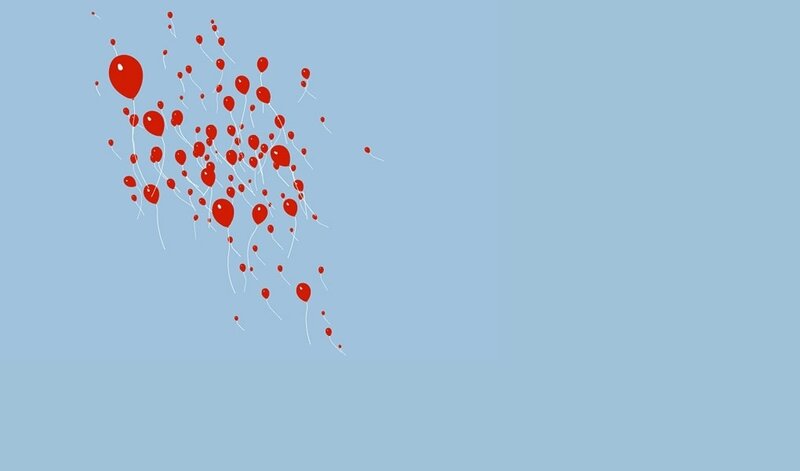 Red balloons floating in sky