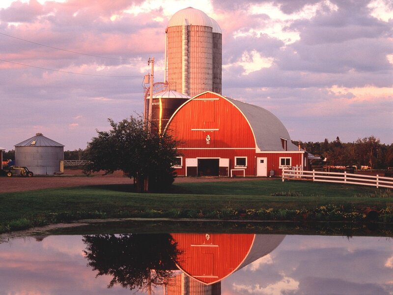 Red barn at sunset with reflection