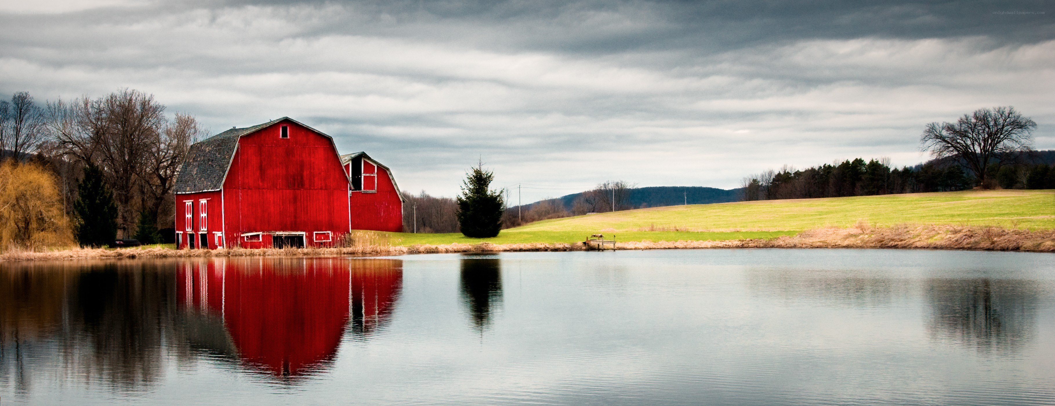 Red barn by a pond