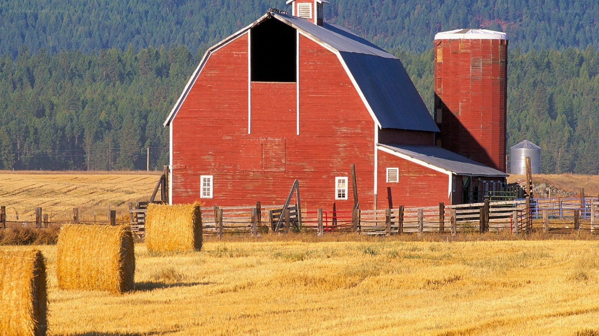 Red barn in a harvested field