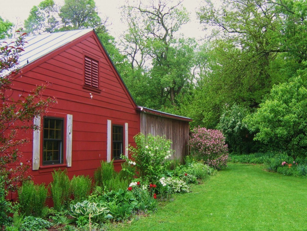 Red barn in a lush garden