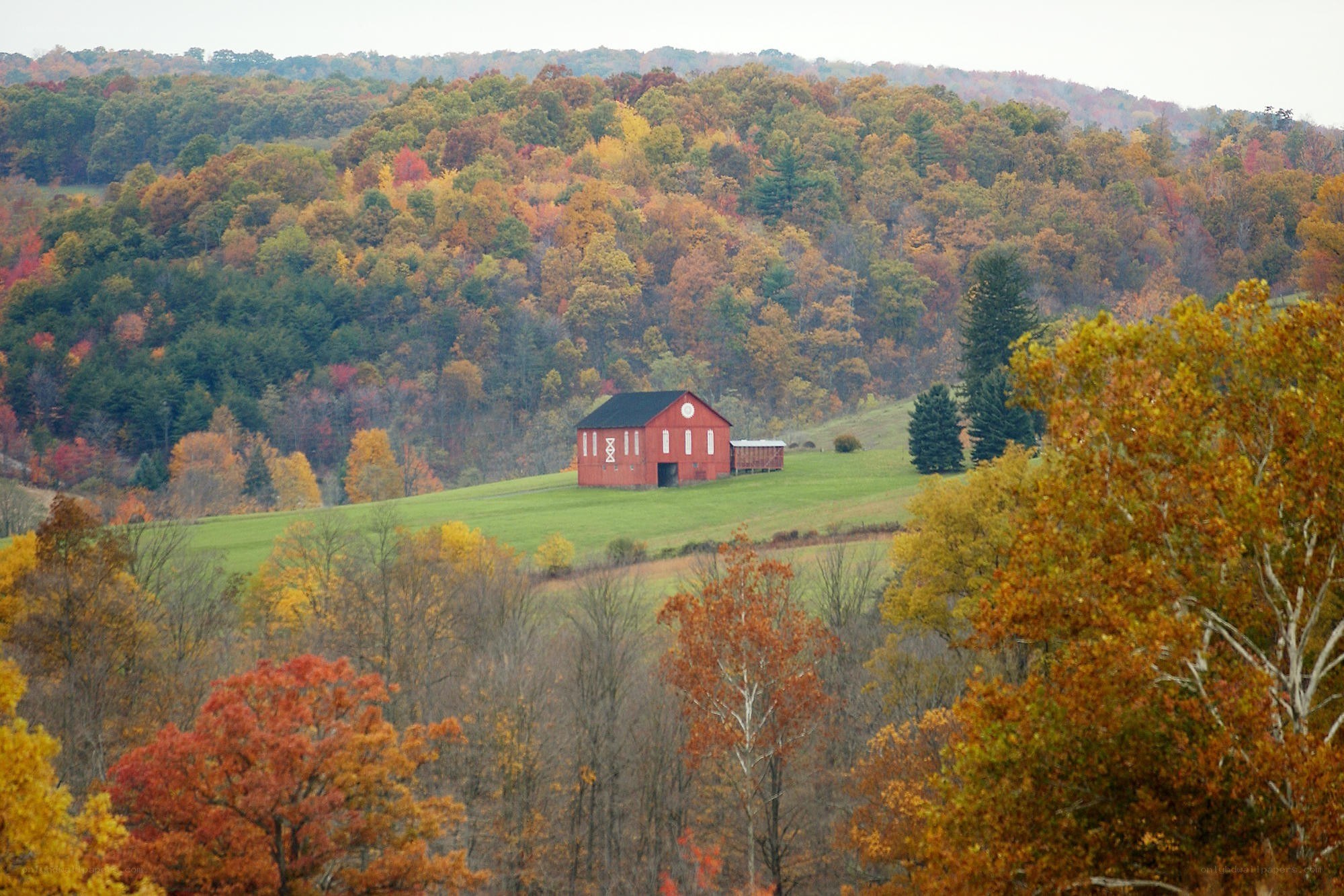 Red barn in autumn hills