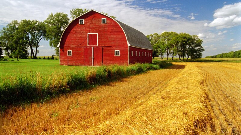 Red barn in harvested field