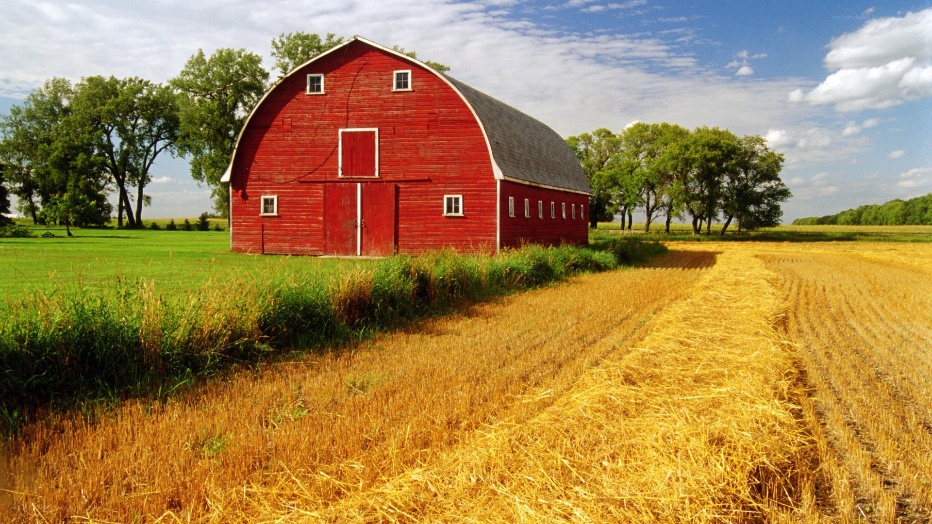 Red barn in harvested field