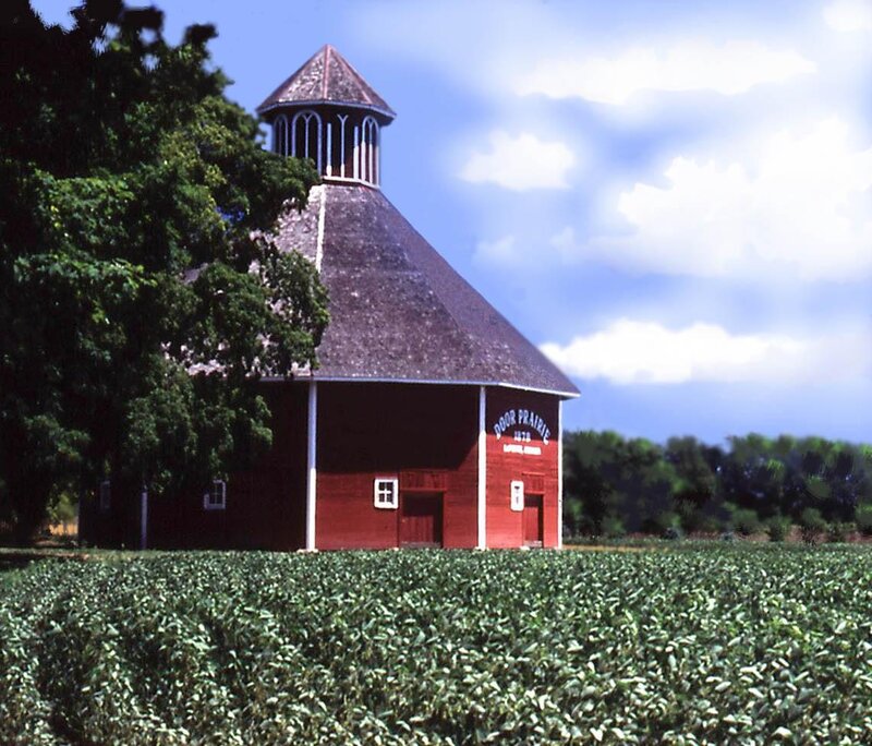 Red barn with cupola in field
