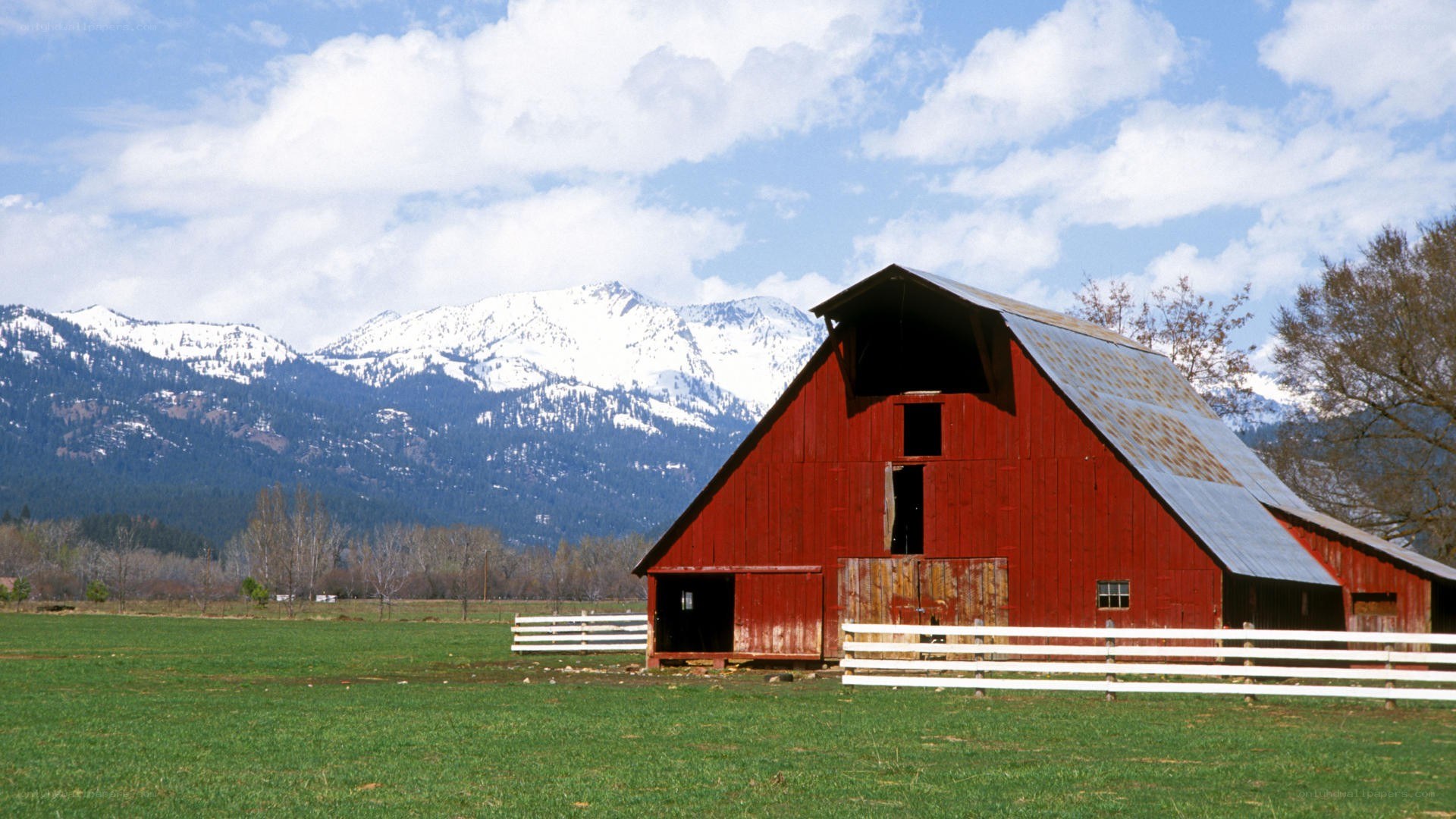 Red barn with snow-capped mountains