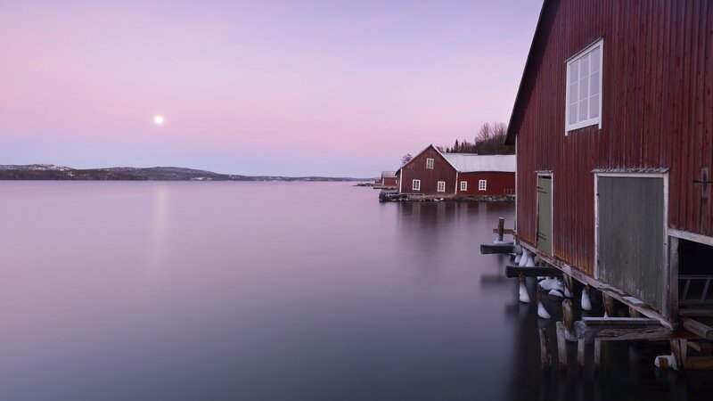 Red barns at dusk by the water