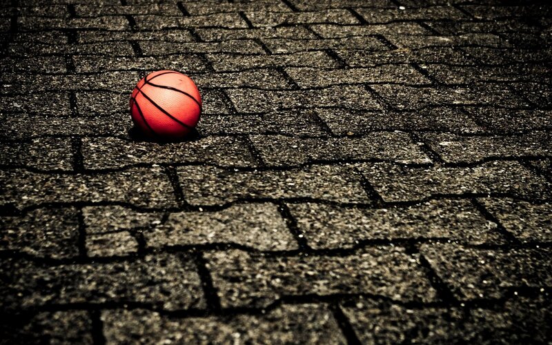 Red Basketball on Pavement — Dramatic, Photograph, Gray