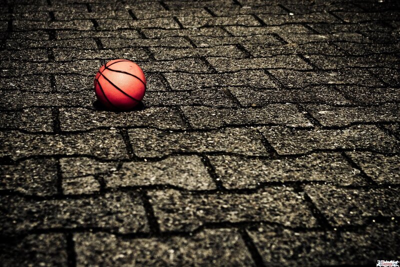 Red Basketball on Pavement — Dramatic