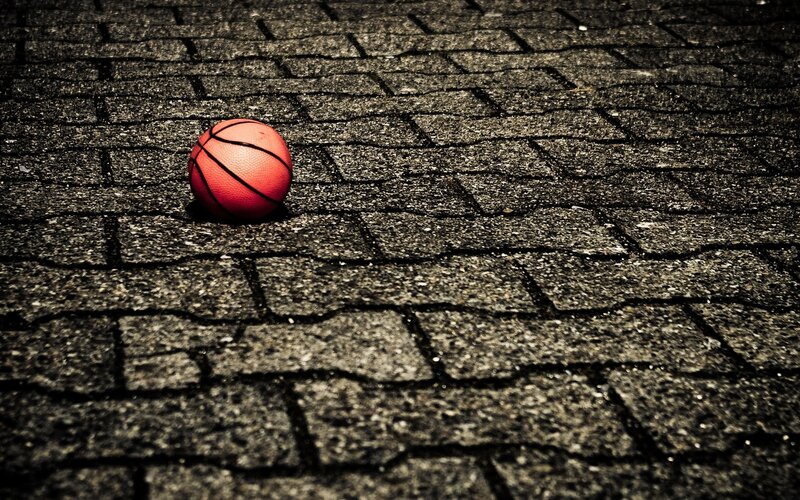 Red Basketball on Pavement