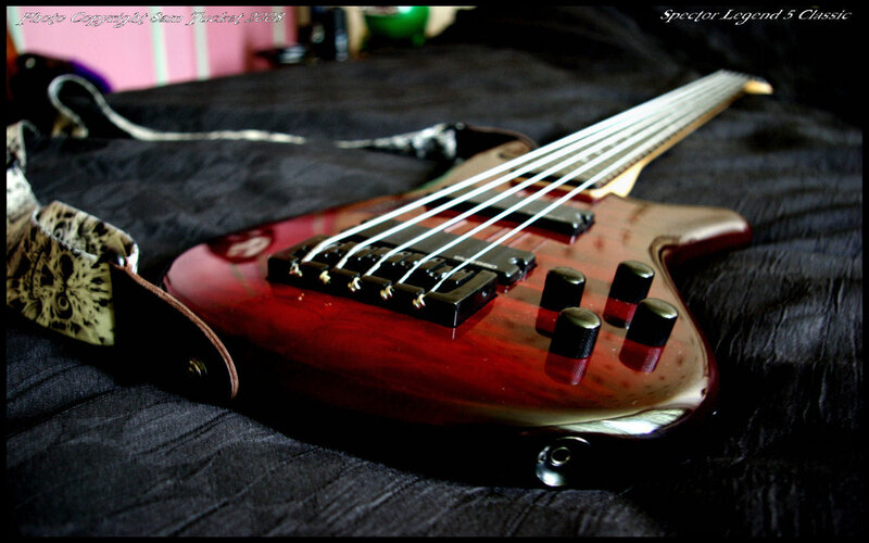 Red bass guitar on black fabric