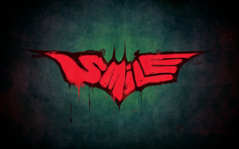 red bat symbol with smile